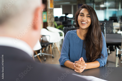 Young female candidate laughing at job interview photo