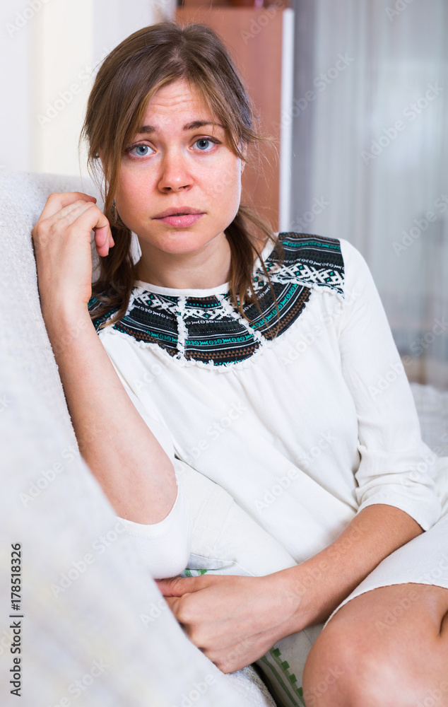 Naklejka premium Portrait of miserable woman at home.