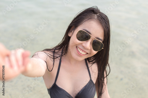 Woman holding Man hand at Sea, People with Summer Conceot, Woman with attractive smiling at beach.