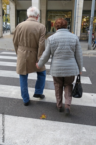 Elderly people walking hand in hand