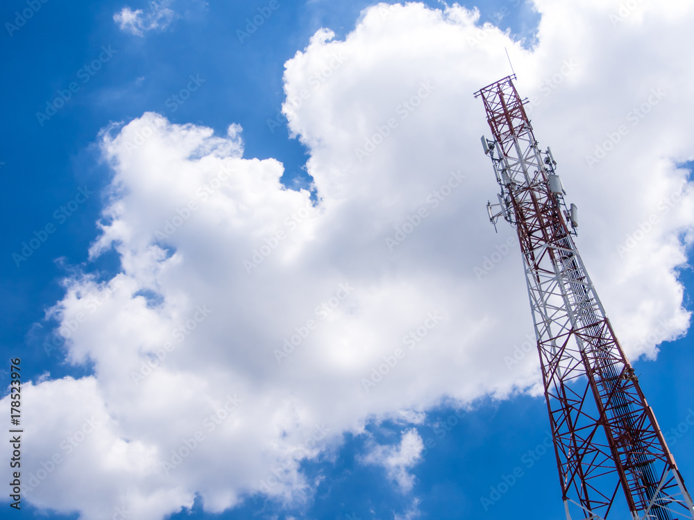 Telecommunication equipment on the steel structure tower and the white clouds in blue sky Telecommunication equipment on the steel structure tower and the white clouds in blue sky