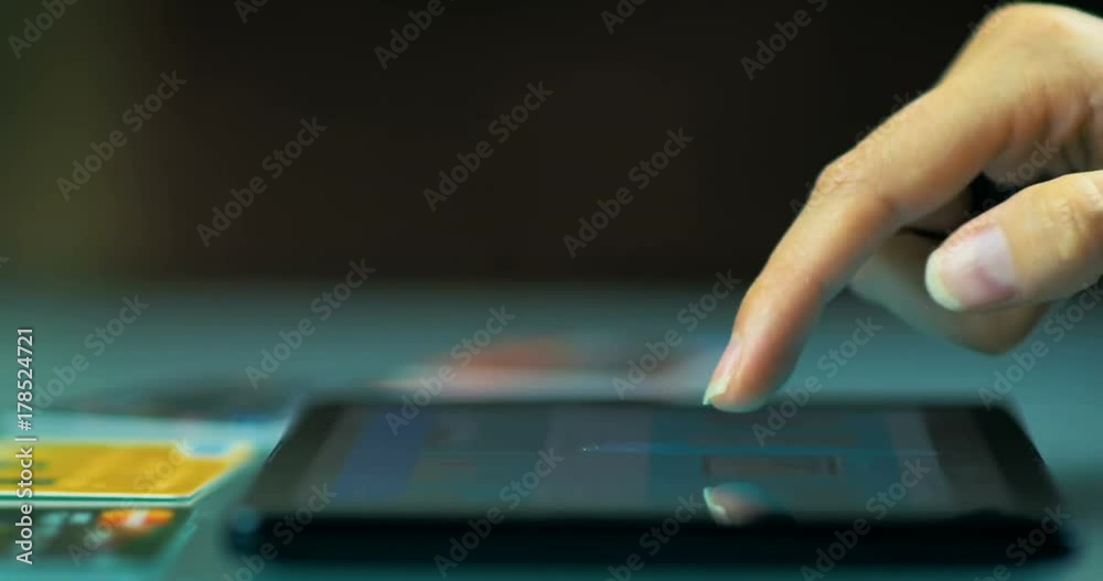 Close-up of a young girl chooses things in the online store on the tablet at home.	