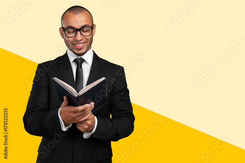 Young african american black student holding books