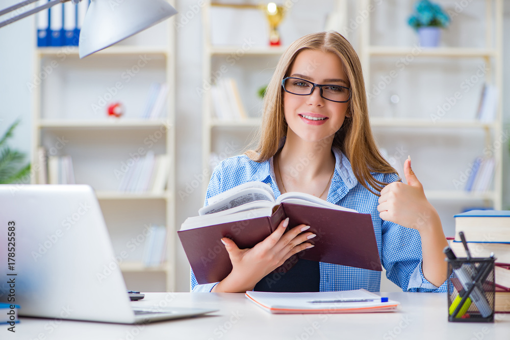Young teenage female student preparing for exams at home