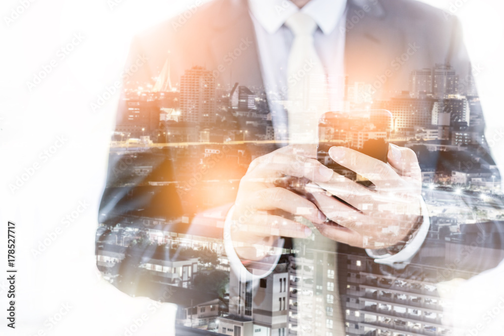 business mission ideas concept double exposure of business man smartphone and city scapr night time business mission ideas concept double exposure of business man smartphone and city scapr night time