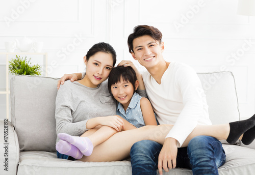 Happy asian family on sofa in living room