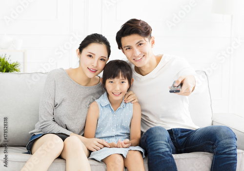 Happy family watching TV in living room