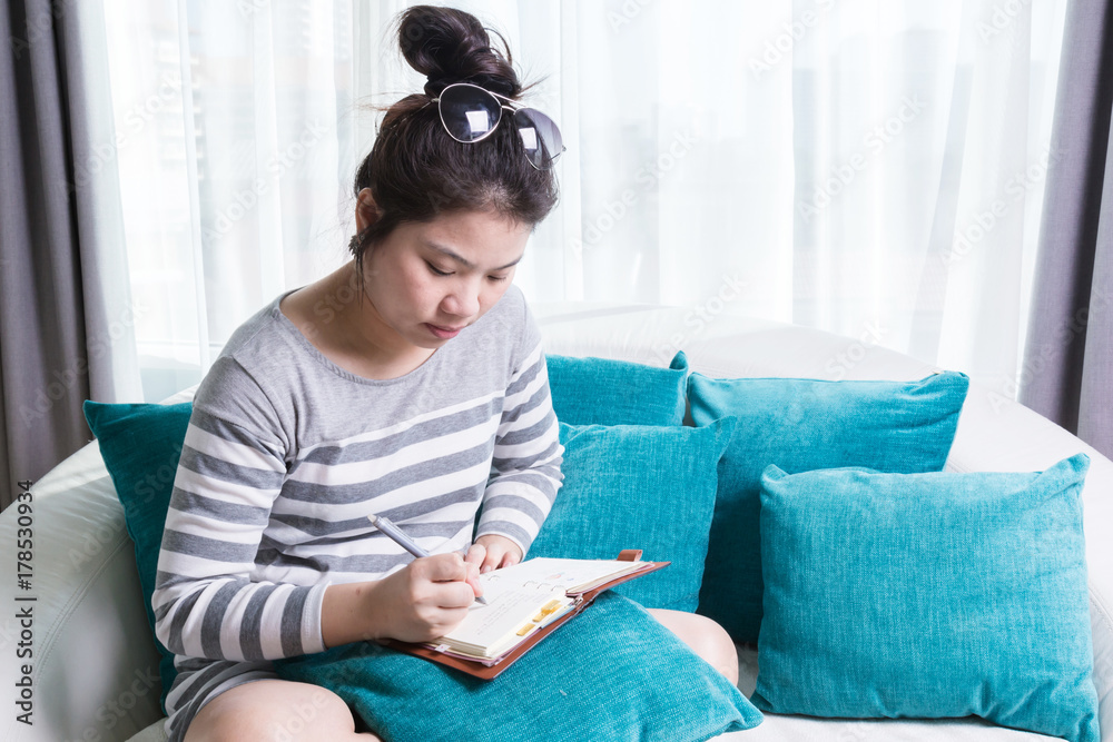 beautiful cute asian girl working with happiness on cozy and casual sofa in bedroom with daylight image tone beautiful cute asian girl working with happiness on cozy and casual sofa in bedroom with daylight image tone
