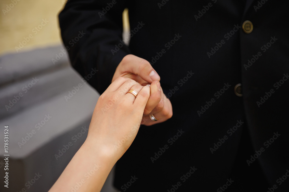 Wedding love. Bride and groom holding hands with wedding or engagement ring Wedding love. Bride and groom holding hands with wedding or engagement ring