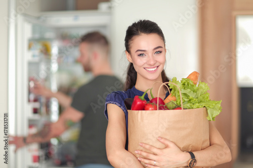 Beautiful young couple is having fun in kitchen at home photo