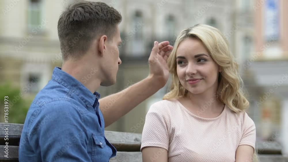 Beautiful blond girl touching boyfriend's face, enjoying her beloved, love