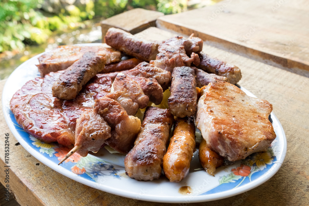Serbian specialities known as rostilj include grilled pork neck, beef steak, pleskavica, cevapi and are served with homemade buns and tortillas Serbian specialities known as rostilj include grilled pork neck, beef steak, pleskavica, cevapi and are served with homemade buns and tortillas