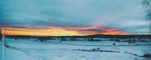 Winter sunset landscape with dramatic sky in Sweden, north scandinavian seasonal hipster background. Panoramic view