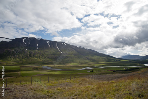 Typical Icelandic landscape  a wild nature of rocks and shrubs  rivers and lakes.