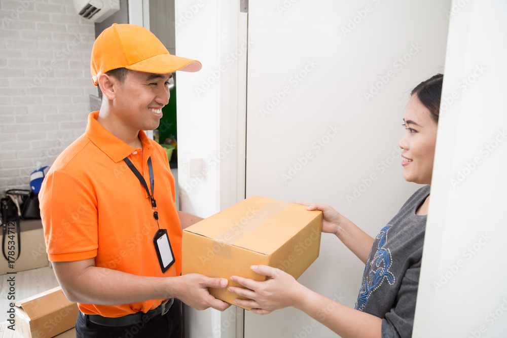 Asian woman accepting a delivery of boxes from deliveryman Asian woman accepting a delivery of boxes from deliveryman