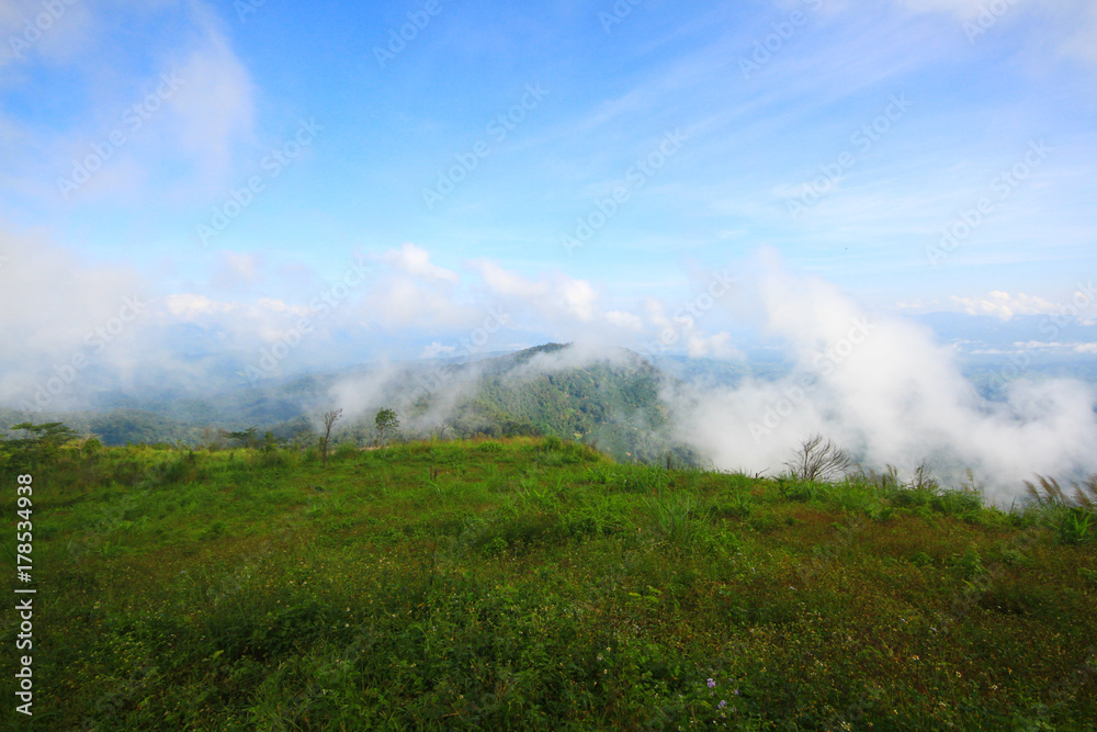 View at a mountain range with morning fog in a mountain valley. View at a mountain range with morning fog in a mountain valley.