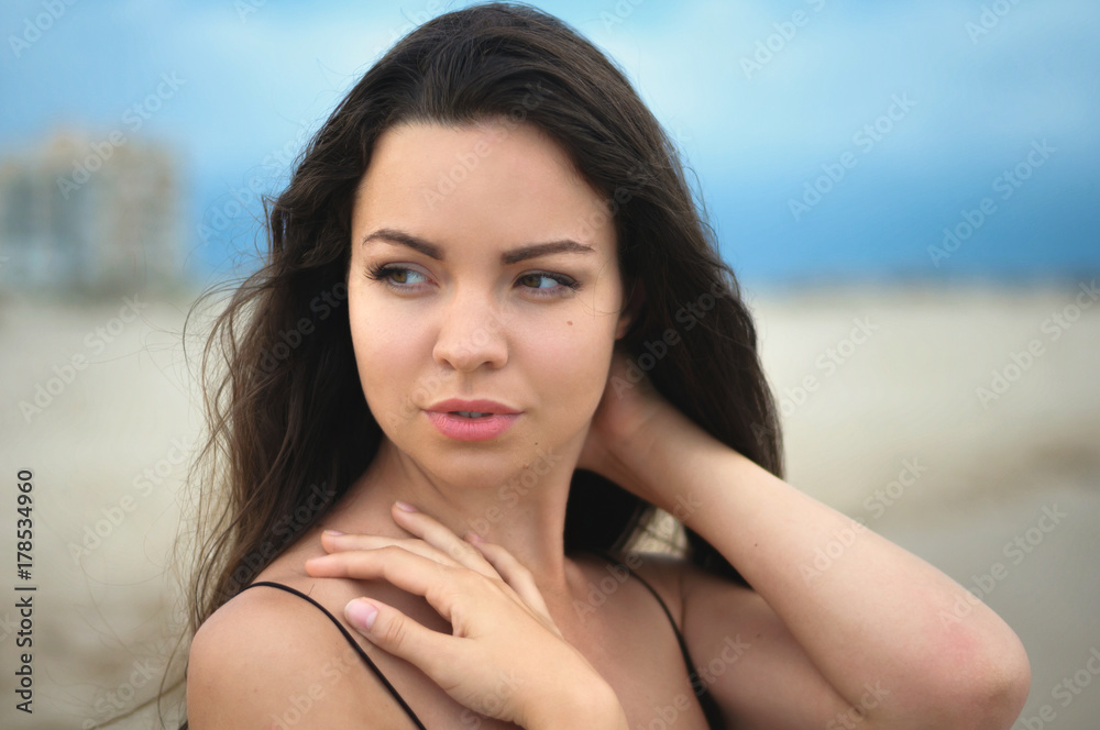 portrait of beautiful young brunette on the beach portrait of beautiful young brunette on the beach