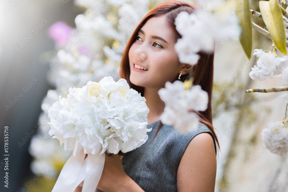 beautiful asian girl happy and relax pose in green garden with white flower fashion pose concept beautiful asian girl happy and relax pose in green garden with white flower fashion pose concept