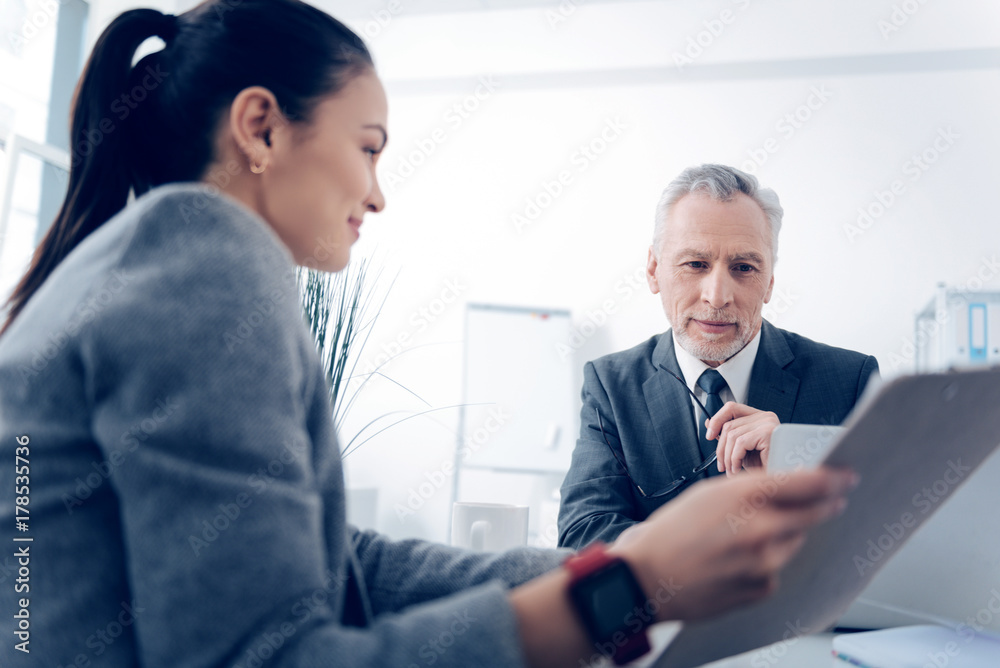 Selective focus on positive chief looking at business document Selective focus on positive chief looking at business document