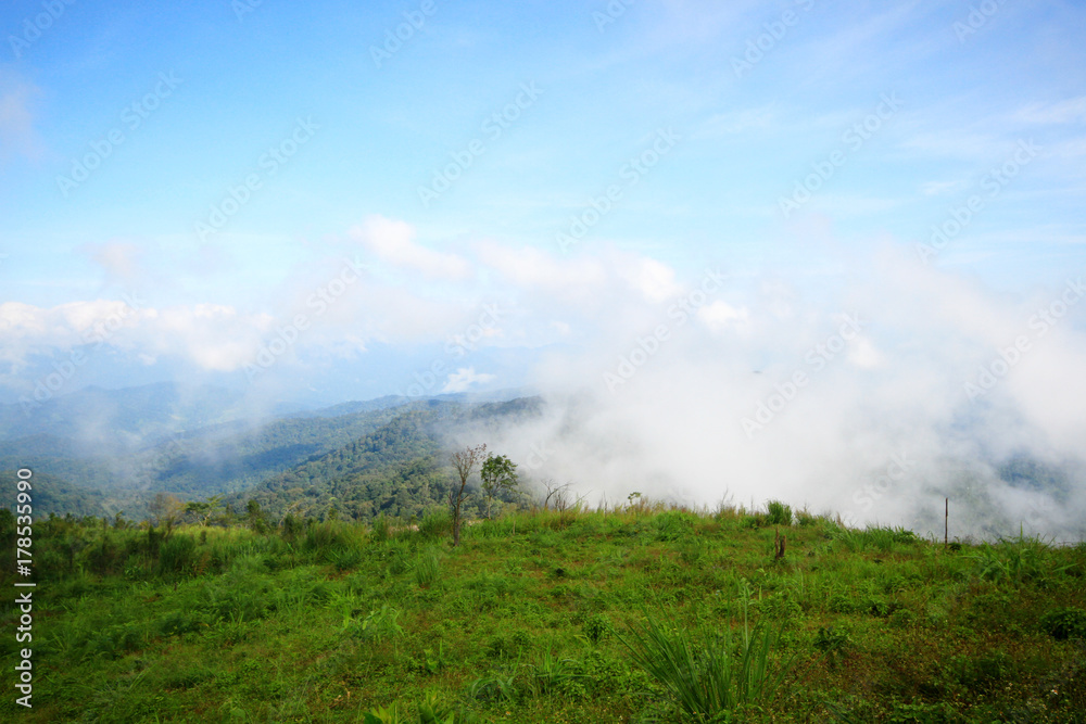 View at a mountain range with morning fog in a mountain valley. View at a mountain range with morning fog in a mountain valley.