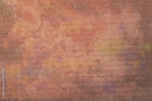 Textured background of colorful stained carton board