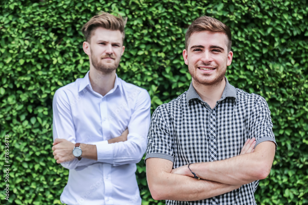 Business people with casual costume standing in a park outdoors with business vision concept Business people with casual costume standing in a park outdoors with business vision concept