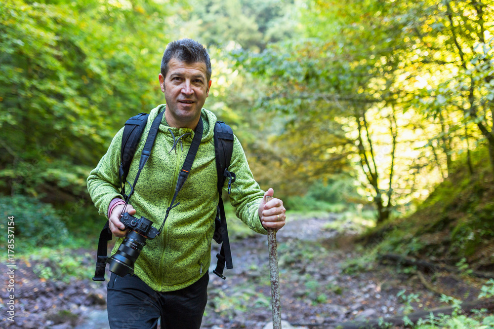 Tourist with camera hiking Tourist with camera hiking