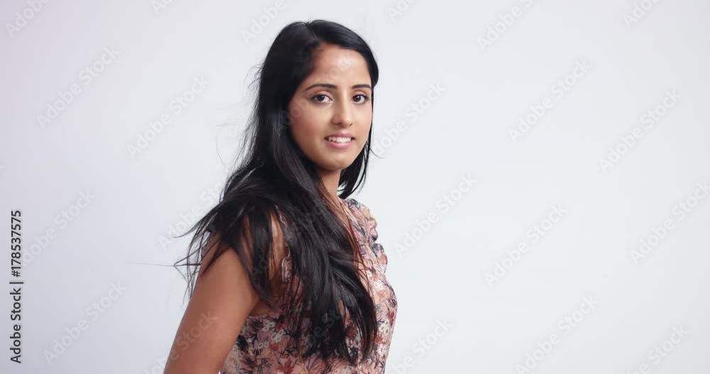 Attractive young woman with black long hair looks sideways and then turns fully to the camera and looks seductively Attractive young woman with black long hair looks sideways and then turns fully to the camera and looks seductively