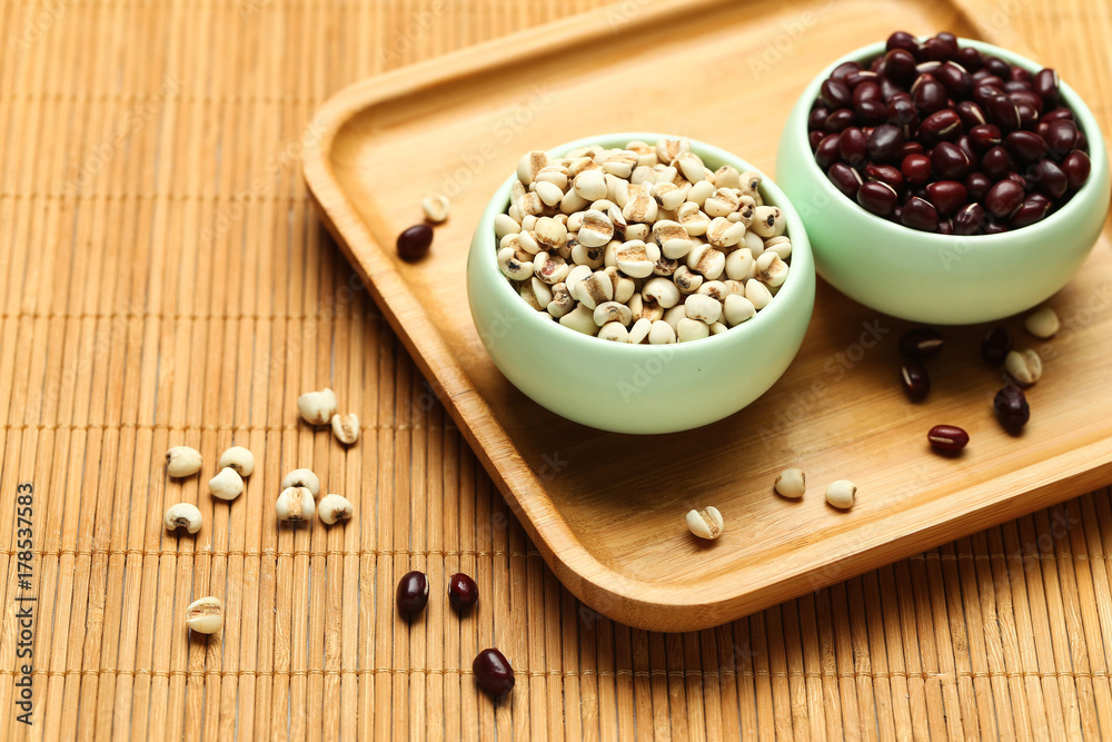 red beans and job’s tears in green bowl on bamboo red beans and job’s tears in green bowl on bamboo