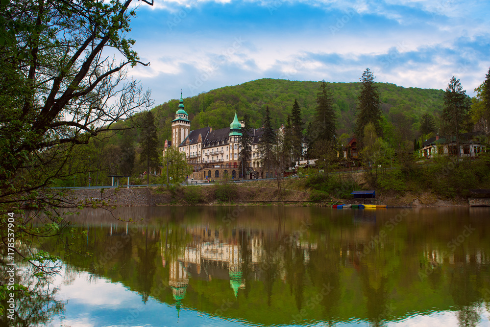 Northern front of Lillafured palace in Miskolc, Hungary. Lake Hamori in foreground with reflections. Travel outdoor landmark background