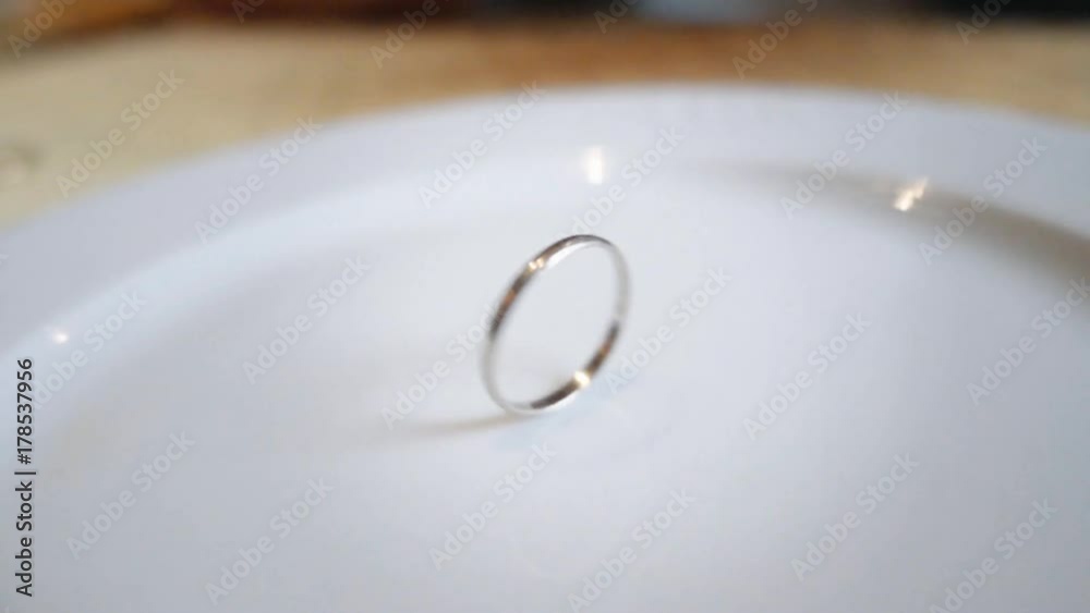 Nervous man spinning his wedding ring leaving to luck his decision. Slow motion