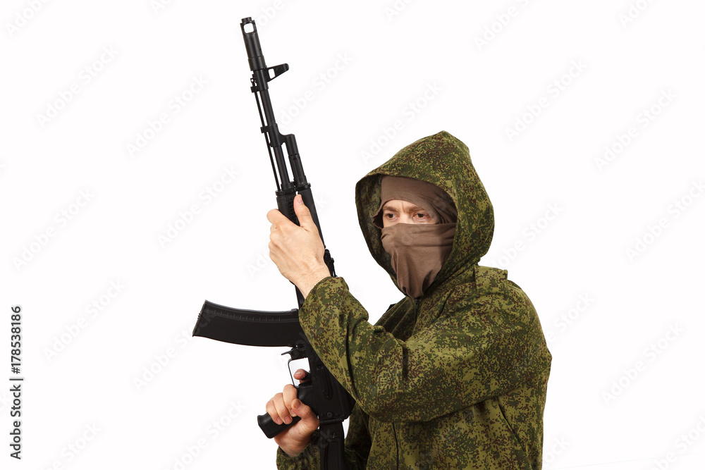 The man in a mask and a submachine gun in hands The man in a mask and a submachine gun in hands