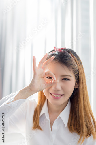 beautiful asian girl pose for beauty concept with white shirt and white room background