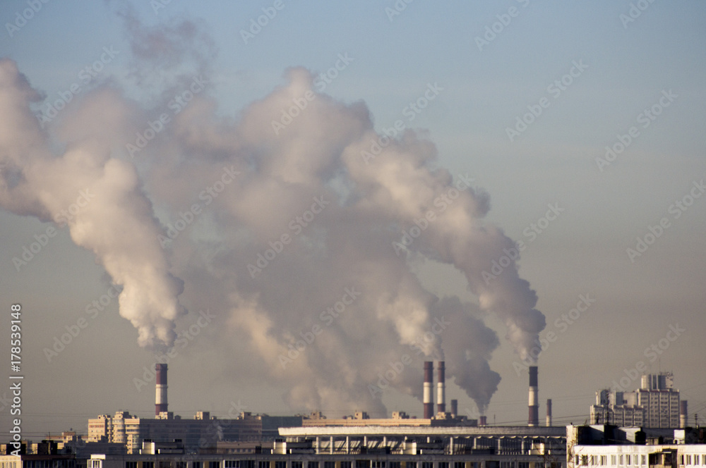 Smoke from pipes of plants against the background of the city Smoke from pipes of plants against the background of the city