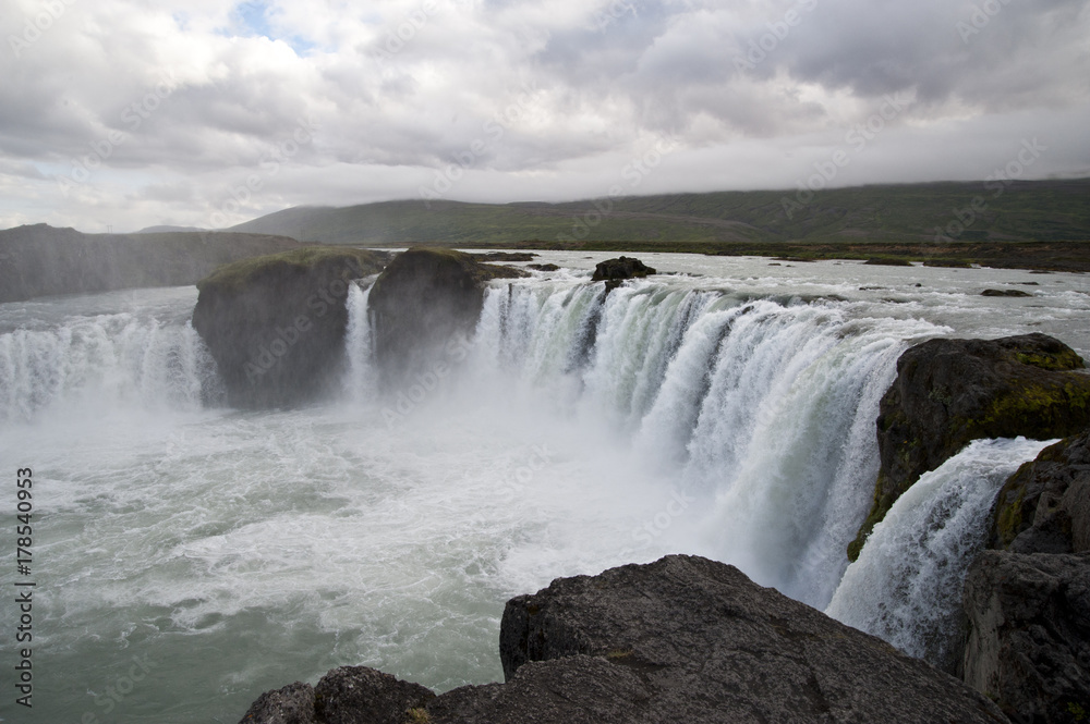 Wonderful view of Gadafoss Falls in a typical Icelandic landscape, a wild nature of rocks and shrubs, rivers and lakes. Wonderful view of Gadafoss Falls in a typical Icelandic landscape, a wild nature of rocks and shrubs, rivers and lakes.