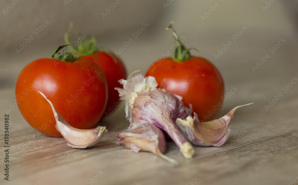 vegetables,red tomatoes and garlic on the table close-up