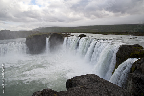 Wonderful view of Gadafoss Falls in a typical Icelandic landscape  a wild nature of rocks and shrubs  rivers and lakes.