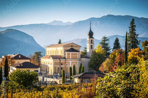 Autumn in Alps with church in Trento