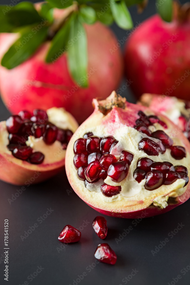 Closeup of pomegranate fruit on a black background Closeup of pomegranate fruit on a black background