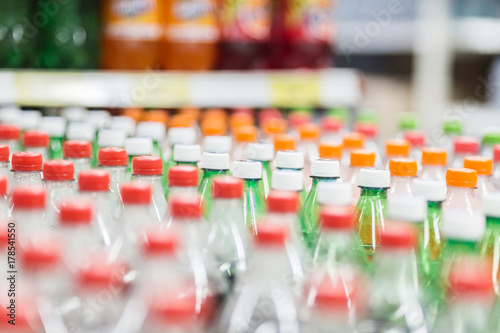 Rows of plastic bottles cap with blur background, bad behavior of city people drinking pop.