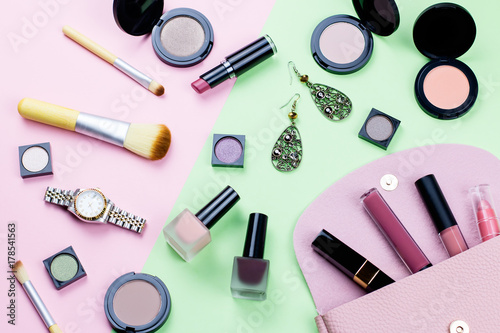 Woman make up products and accessories on pastel background