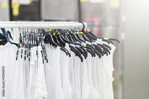 Fashion beautiful clothes hang on a shelf on blurred background