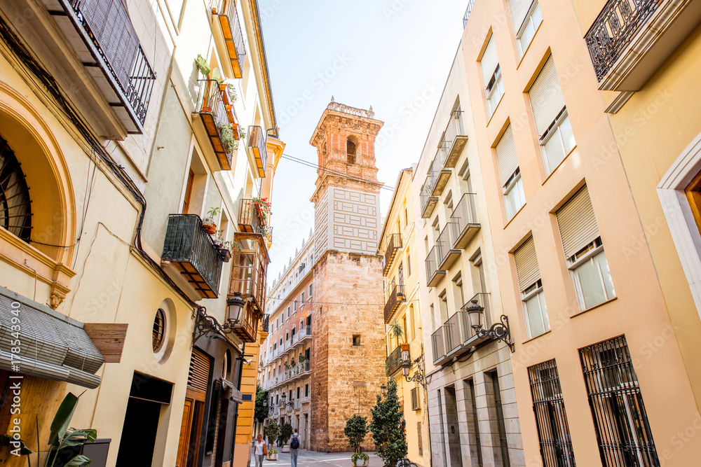 Street view with beautiful old buildings and saint Bartolomeu tower in Valencia, Spain