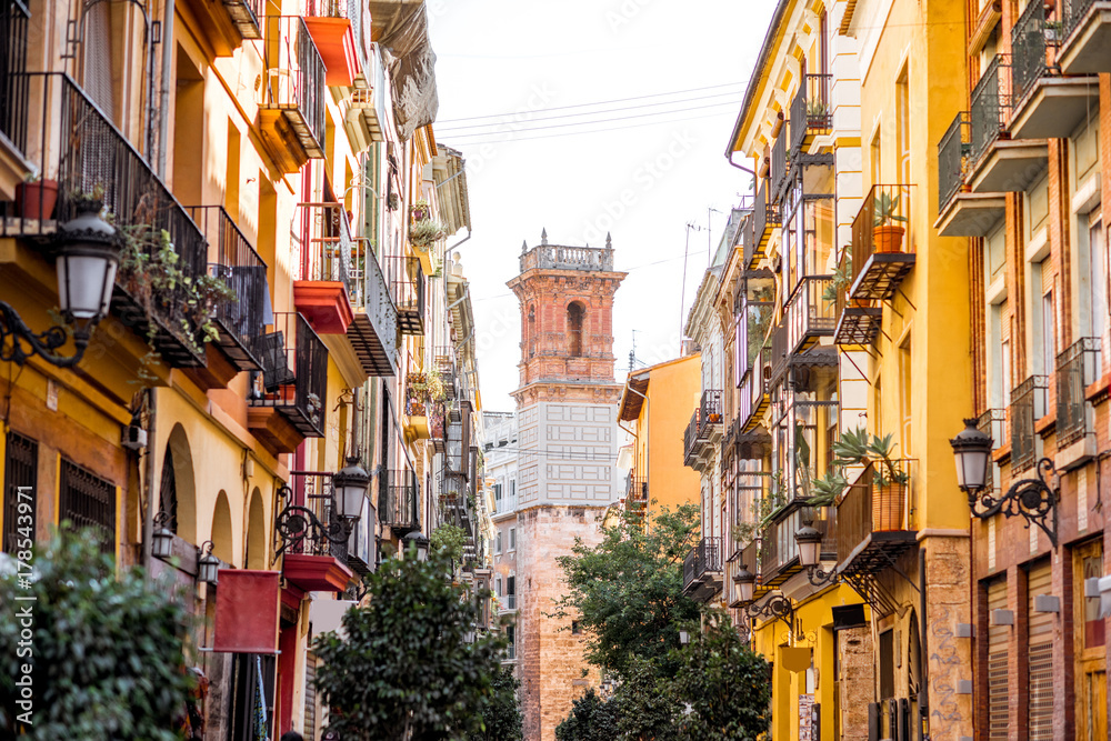 Street view with beautiful old buildings and saint Bartolomeu tower in Valencia, Spain