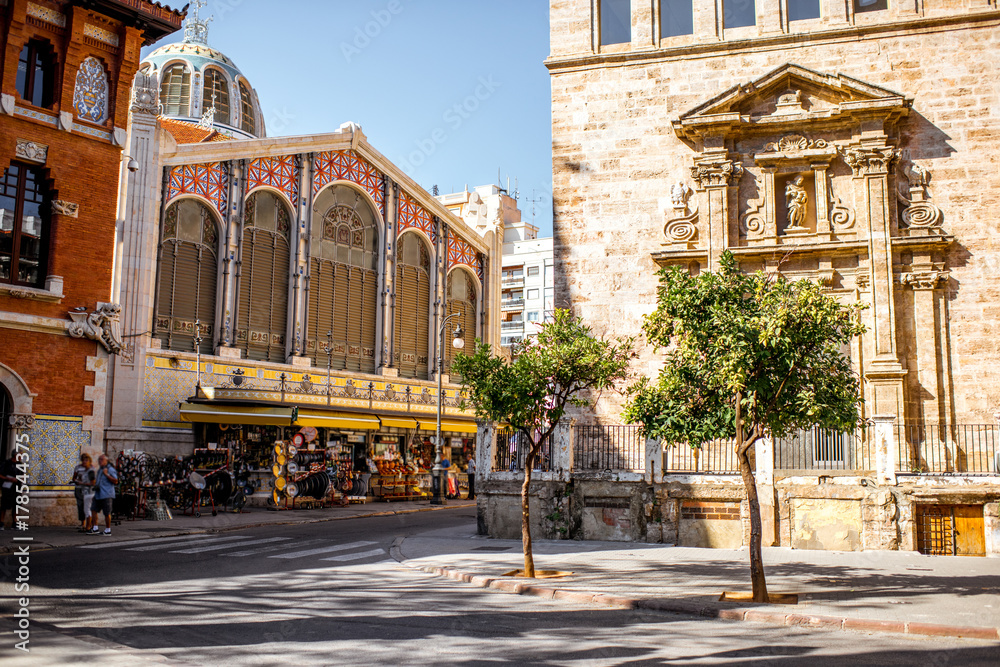 Fototapeta premium Street view with saint Joan church and famous food market Central in Valencia city, Spain