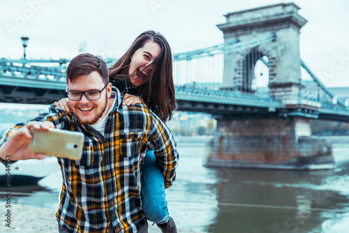Photography lovely cople taking selfie bridge on background