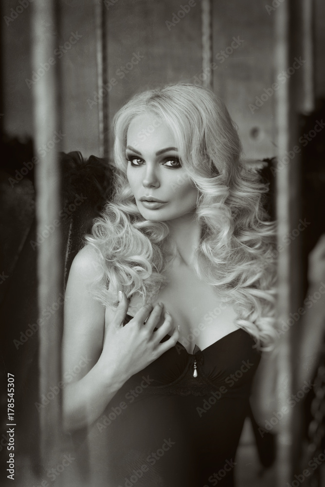 Naklejka premium blond woman with black wings in a cage. Angel, mysticism