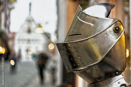 A knight's helmet in front of a arts and gifts shop in Rothenburg in Germany