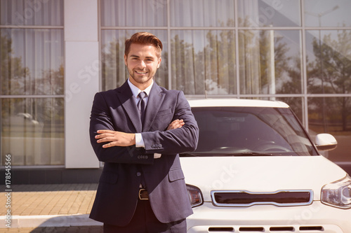 Salesman standing near new ...