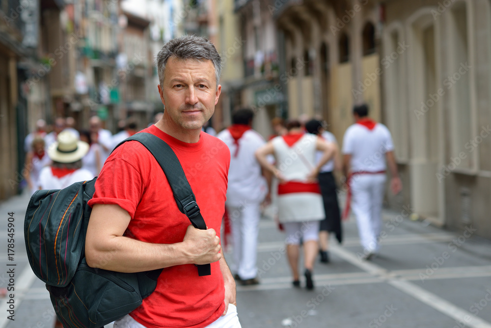 Man in celebrating San Fermin festival in traditional white abd red clothing with red necktie, 08 July 2017, Pamplona, Navarra, Spain. Man in celebrating San Fermin festival in traditional white abd red clothing with red necktie, 08 July 2017, Pamplona, Navarra, Spain.